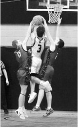 Caleb McDonald and Eastyn Schaefer team up and both get a hand on Trenton Keena's shot, blocking him from scoring. Photo by Larry Stokke