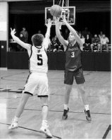 Dawson Downs drops a 3-point shot in the hole when the Cards played the Titans. Photo by Larry Stokke