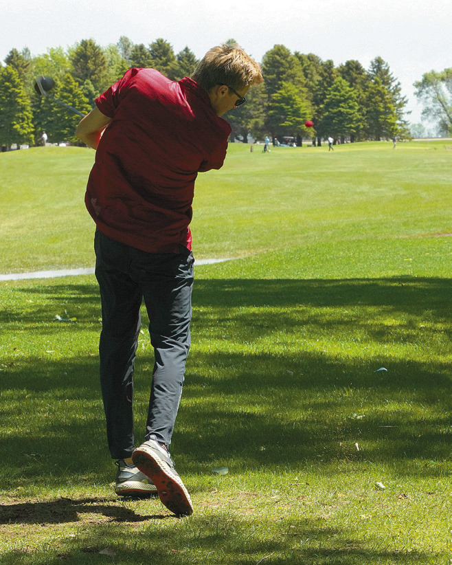 The Cardinals’ Rudy Moser after a powerful swing at the state golf tournament. Photo by Larry Stokke.