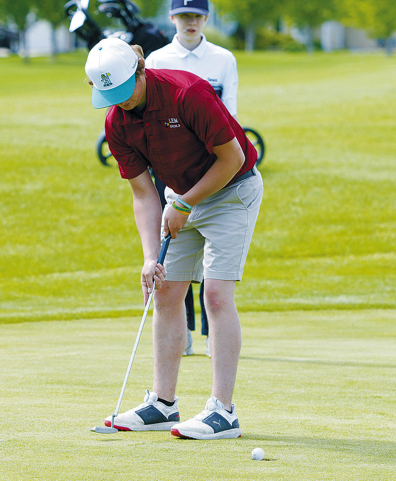 Tyler Kram putting for the Cardinals at state golf. Photo by Larry Stokke. cont’d. on page B2