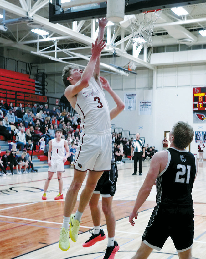 Cody Amble drives to the basket and lays in a bucket in the win over the Titans. Photo by Larry Stokke.