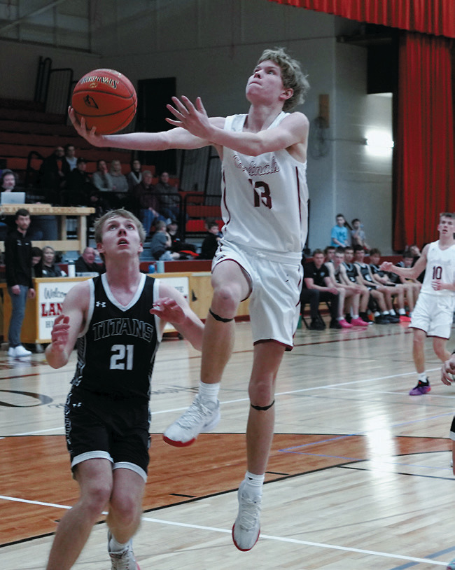 Caleb McDonald lays in a nice right hand layup in the win over the Titans. Photo by Larry Stokke.