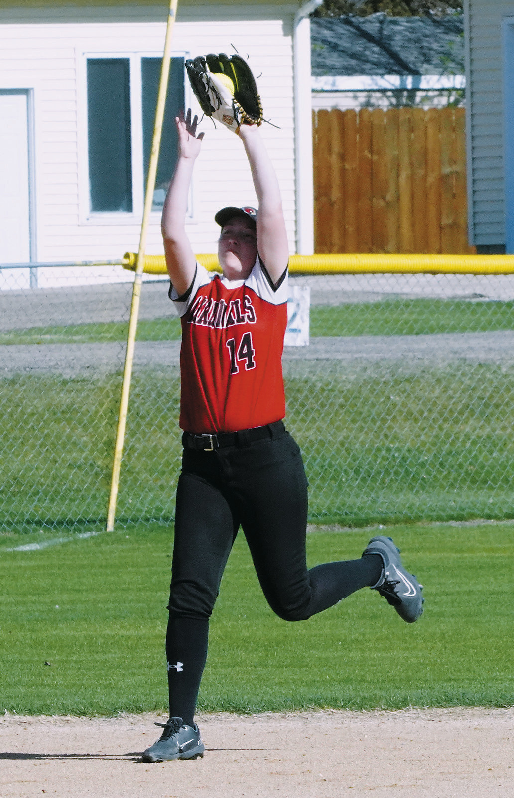 Nadia Lewis catches a pop fly for a third out against the North Border Grizzlies. Photo by Larry Stokke.