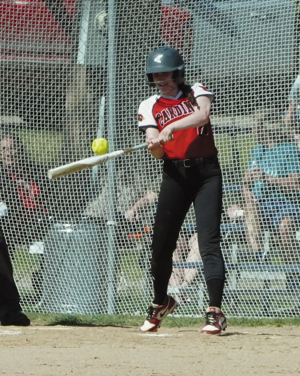 Bridget Pankratz connects for a base hit against the Grizzlies. Photo by Larry Stokke.