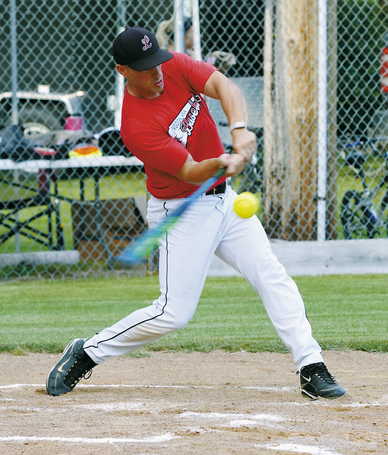 Zach Schaefer drives one for a base hit in the Legacy Alumni Softball Tournament. Photo by Larry Stokke.
