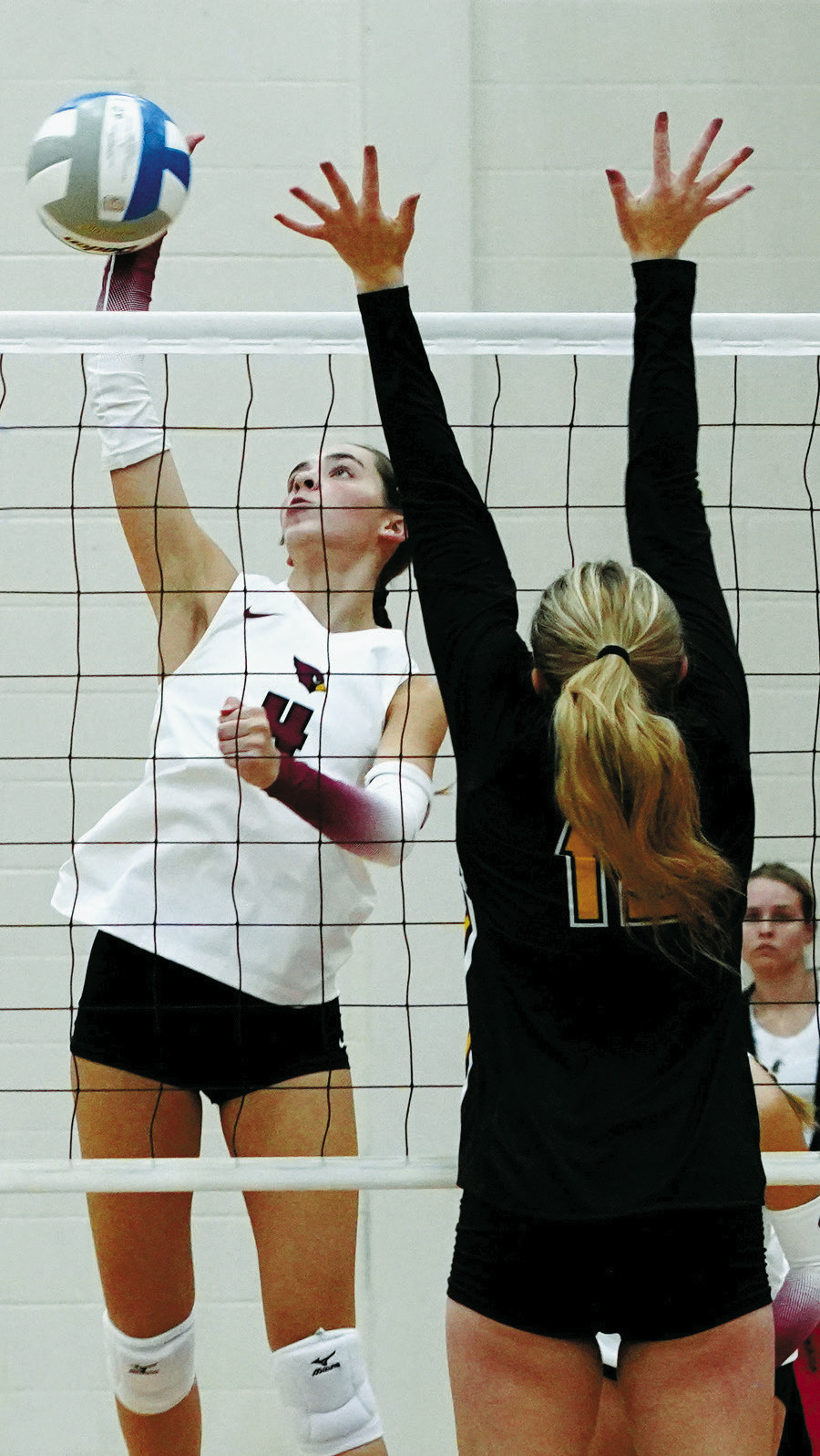 Avery Lorenz slams down a kill against Park River. Photo by Larry Stokke.