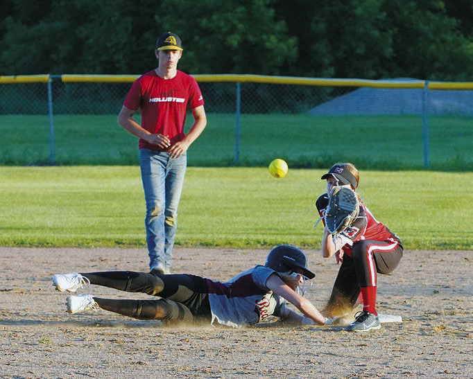 Jada Moen slides safely back to second base. Photo by Larry Stokke.