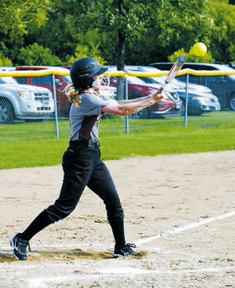 Nora Van Heerden connects for a base hit against Midway/Minto. Photo by Larry Stokke.