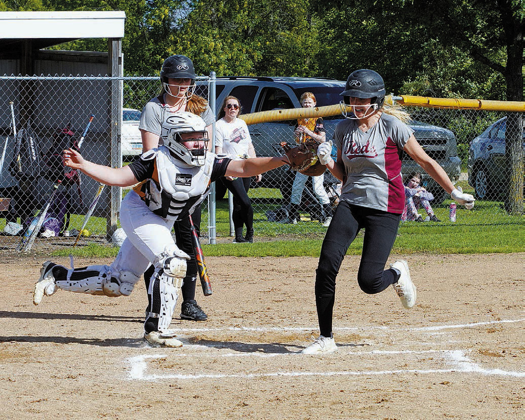 Jada Moen scores a run in the Reds win over Park River on July 2 in Crystal. Photo by Larry Stokke.