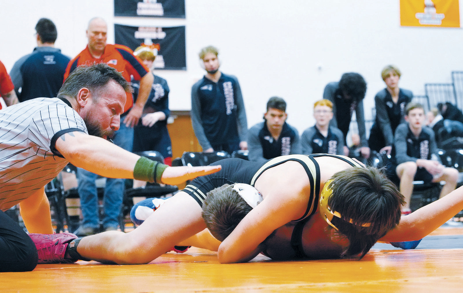 Abel Enerson gets the pin as former Langdon wrestler Marty Mikkelsen signals the pin. Photo by Larry Stokke.