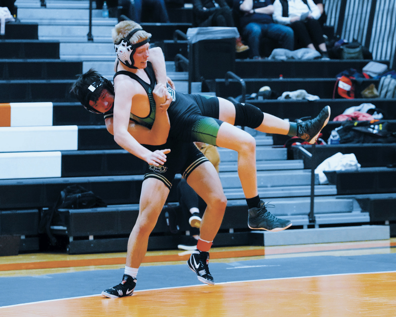 Logan Werner takes his Thompson opponent off his feet and pins him for a win at the Larimore meet. Photo by Larry Stokke.