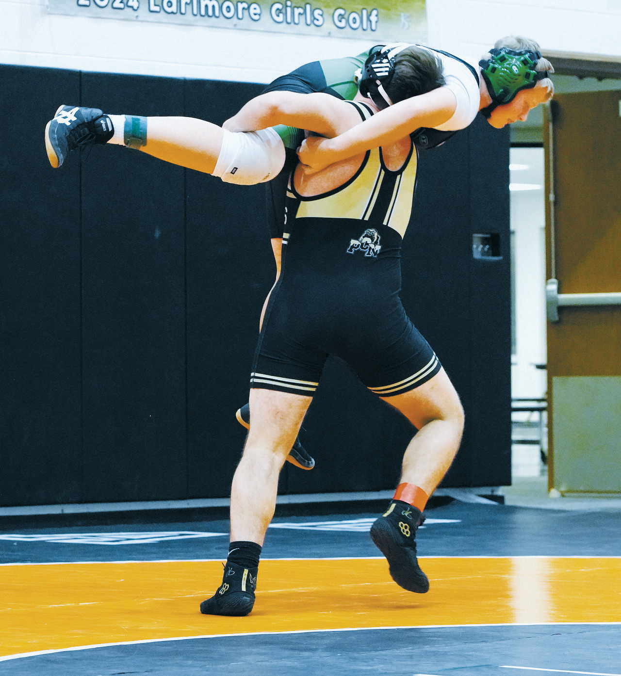 Aiden Werner powers his opponent high in the air and brings him to the mat for a win. Photo by Larry Stokke.