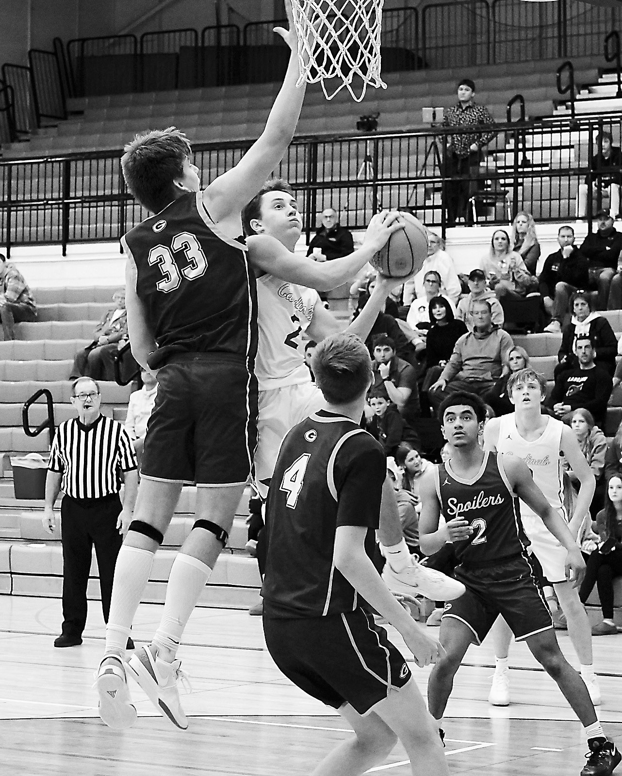 Player of the Game Tanner McDonald gets fouled going in for a basket, sending him to the line where he drained a couple free throws. Photo by Larry Stokke.