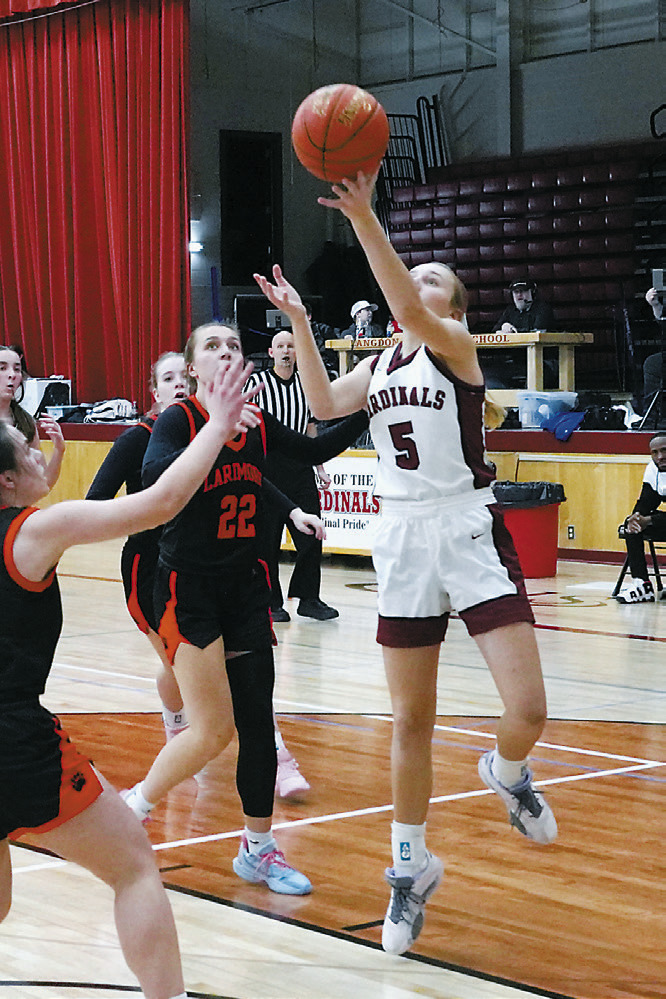 Kemi Morstad rolls the ball off her fingertips to add two points to the Cards score. Photo by Larry Stokke.