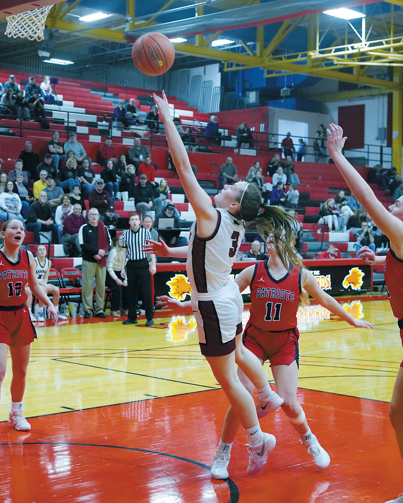 Meredith Romfo drives down the lane and lays in a basket. Photo by Larry Stokke.