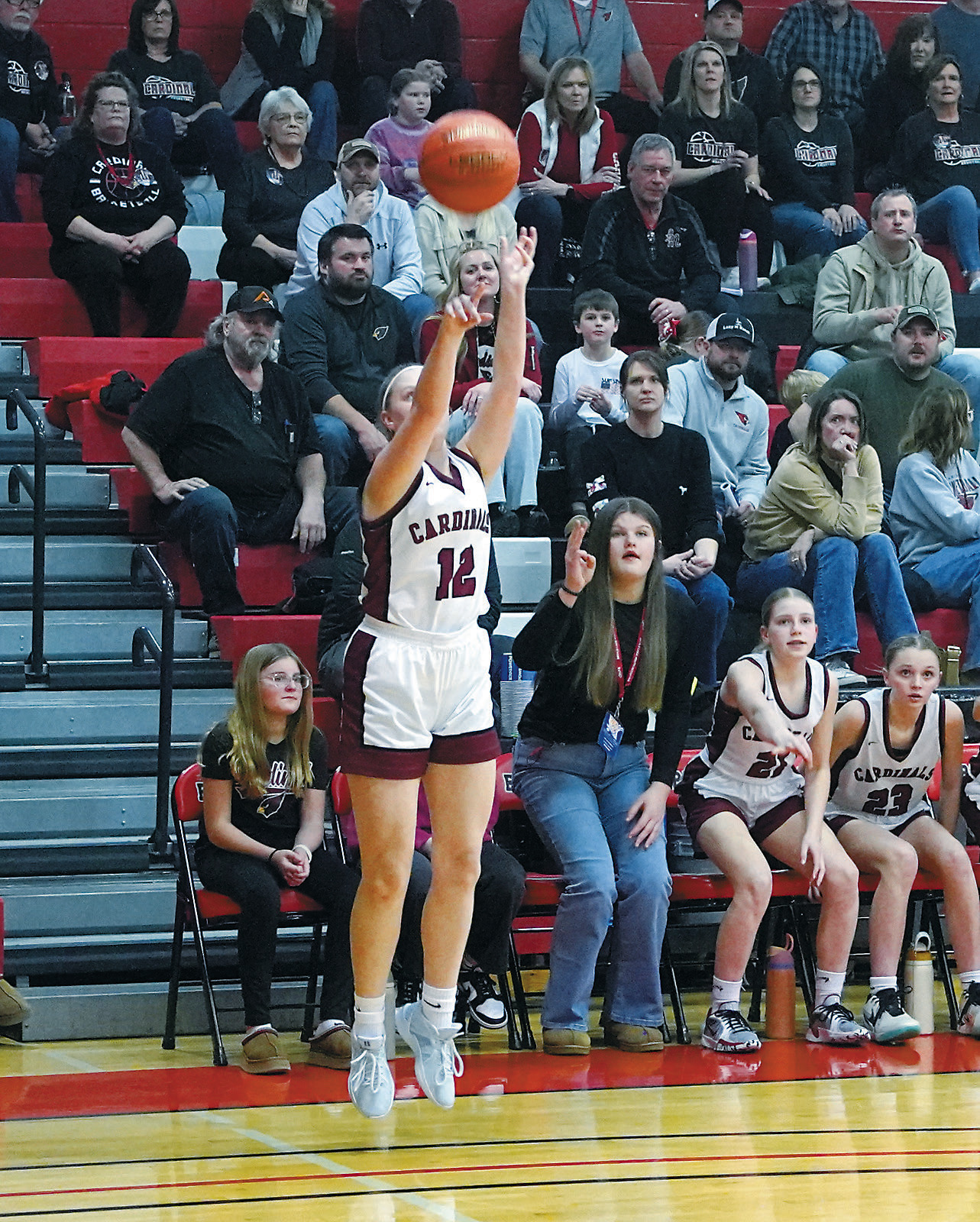 Mikaela Olson fires off a three point shot in the Cards' win over the M-P-C-G Patriots. Photo by Larry Stokke.