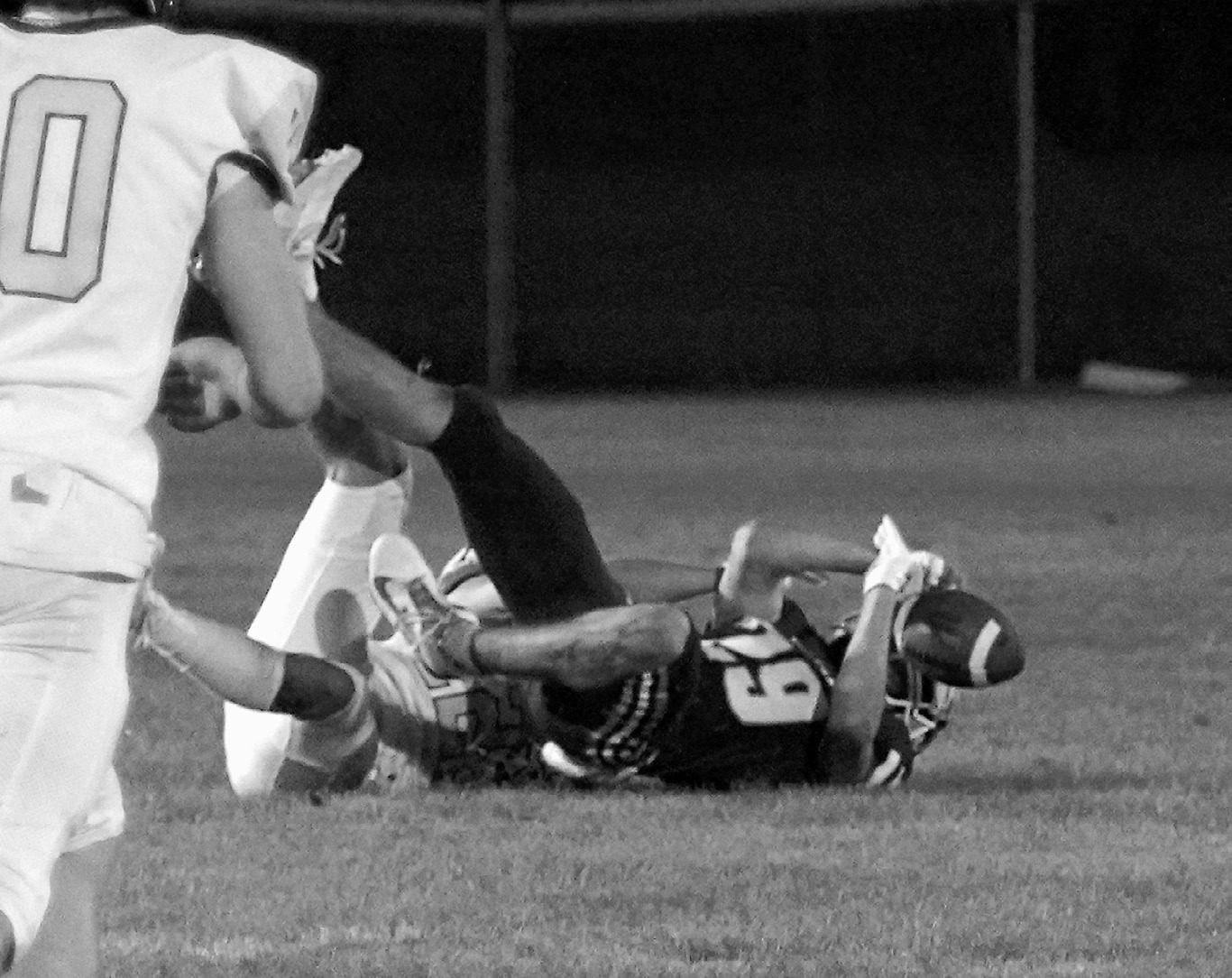 Weston Cosley tackles Jory Samuelson, causing a fumble. Photo by Larry Stokke.