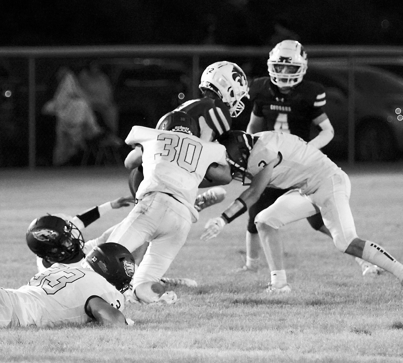 Along with their teammates, Brody Berg and Oakley Brown tackle the Cougars’ Hunter Anderson in Rolla on Aug. 22. Photo by Larry Stokke.