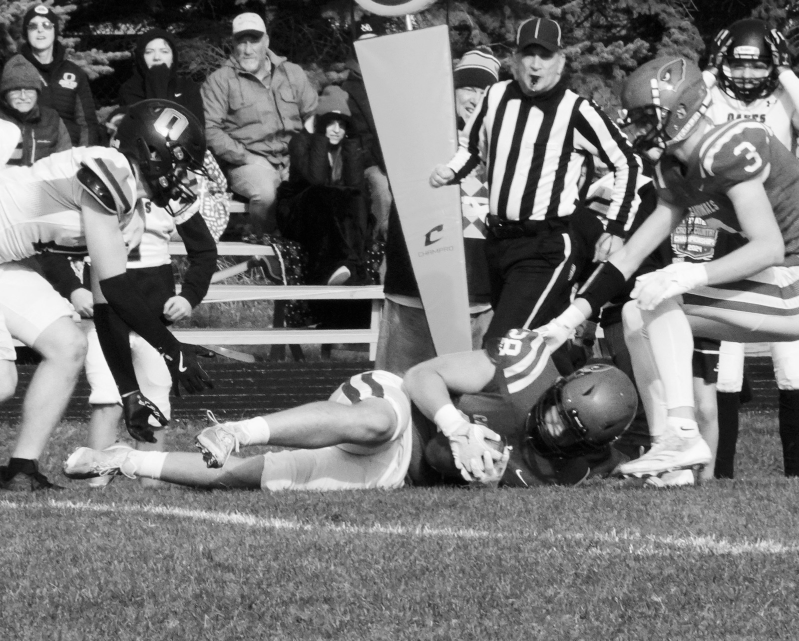 Theo Romfo jumps on a loose ball in the Cards’ win over Oakes to advance to the next round of playoffs. Photo by Larry Stokke.