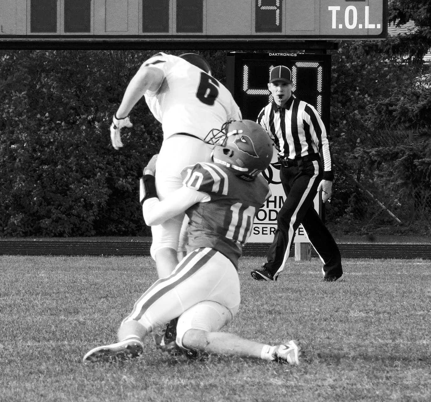 Maddux Stremick tackles an Oakes player, preventing him from scoring. Photo by Larry Stokke.