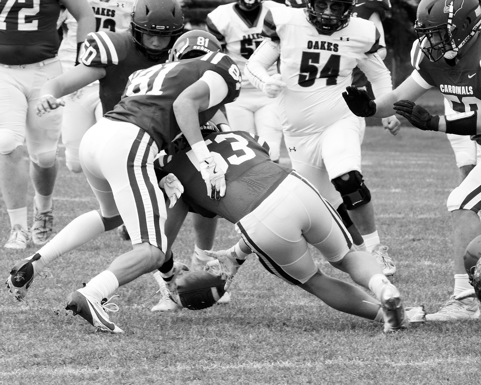 Colten Hein grabs an Oakes fumble and turns the ball over to the Cardinals. Photo by Larry Stokke.