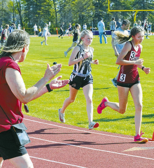 Olivia Lorenz (right #3) qualified for state in the 1600M run. Photo by Larry Stokke.