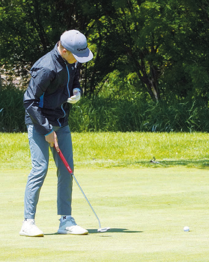North Border golfer, Bjorn Evenson, takes a swing at state golf. Photo by Larry Stokke. Kaden Moore, representing the Eagles, eyes the ball at the state golf tournament. Photo by Larry Stokke.