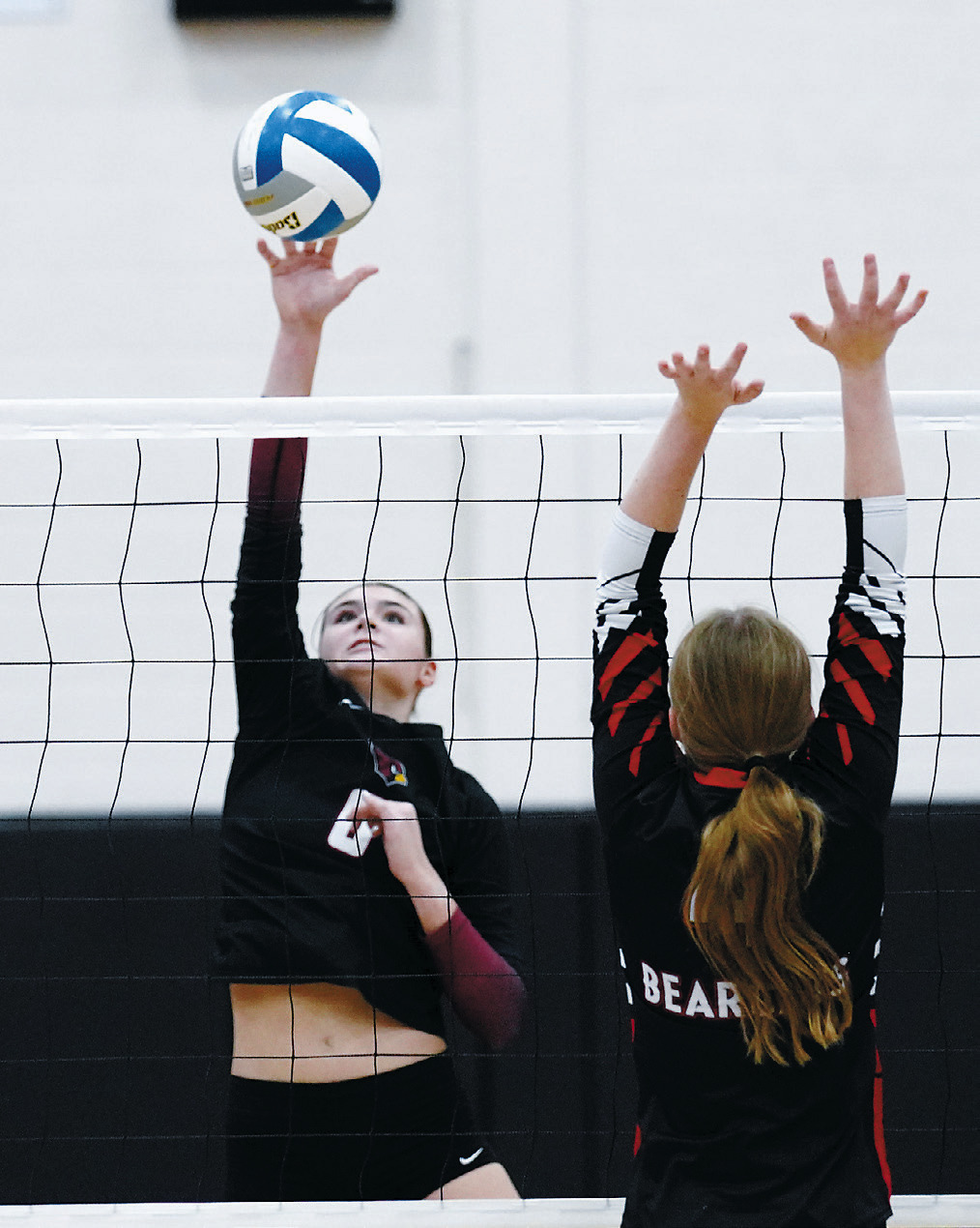 Taya Feist with one of her three kills, along with five blocks and six digs in the Cards' three set sweep of the North Star Bearcats. Photo by Larry Stokke.