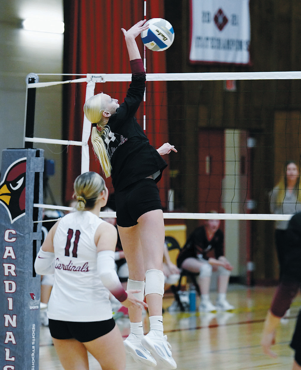 Mya Swanson slams down one of her eight kills. She had a great game with 19 digs as well. Photo by Larry Stokke.