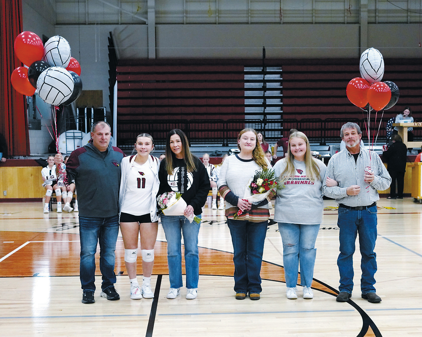 Senior Night for the Lady Cardinals (L-R) Jeff Ratzlaff, Raeleigh, Kim Ratzlaff, Michelle Briscoe, Haven, Kevin Radway. Photo by Larry Stokke.
