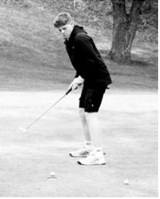 Korbyn Rollness watches his putt drop into the cup during the Larimore meet on May 15 and finished with an 83. Photo by Larry Stokke