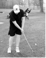 Maddux Busse chips onto the green during golf action in Larimore on May 15. Photo by Larry Stokke