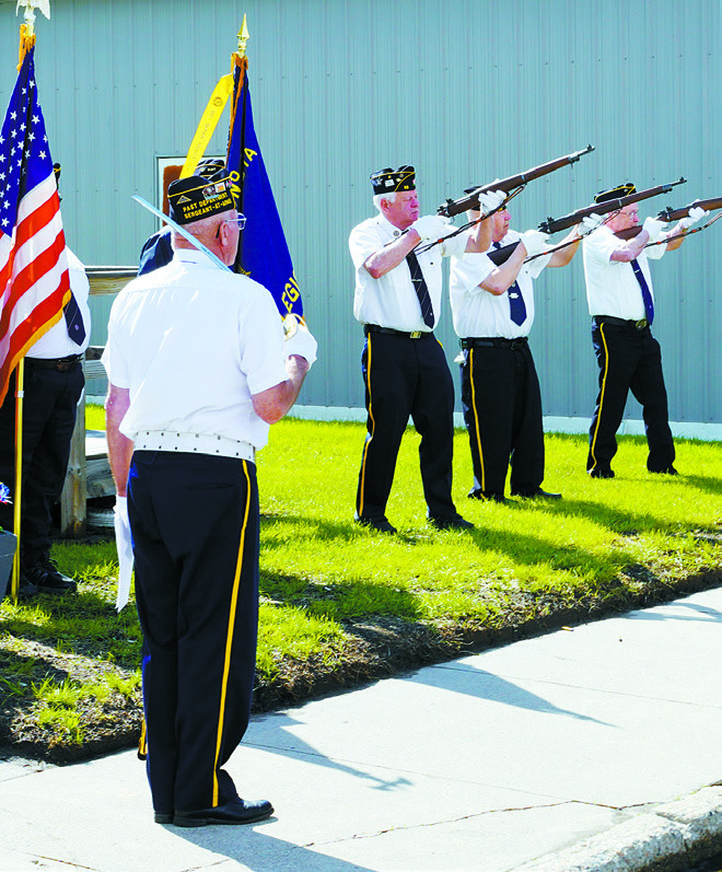 The Langdon Post 98 Honor Guard concluded the program with the Retiring of the Colors. The Honor Guard consists of Danny Lill, Harvey Metzger, and Larry Murie. Photo by Larry Stokke.