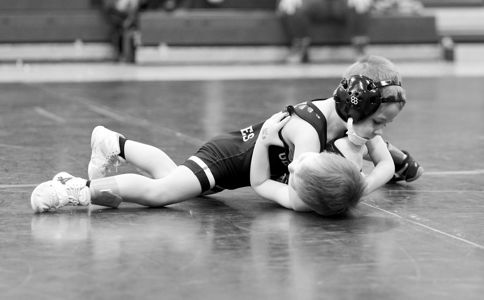 Gunnar McKay attempts to pin his opponent. Photo by Larry Stokke.