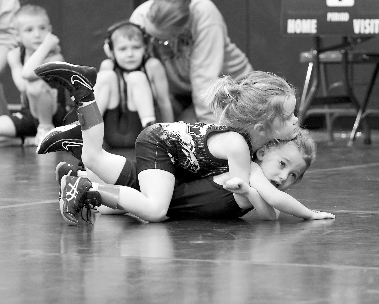 Leni Otterson works at turning her opponent over for a pin. Photo by Larry Stokke.