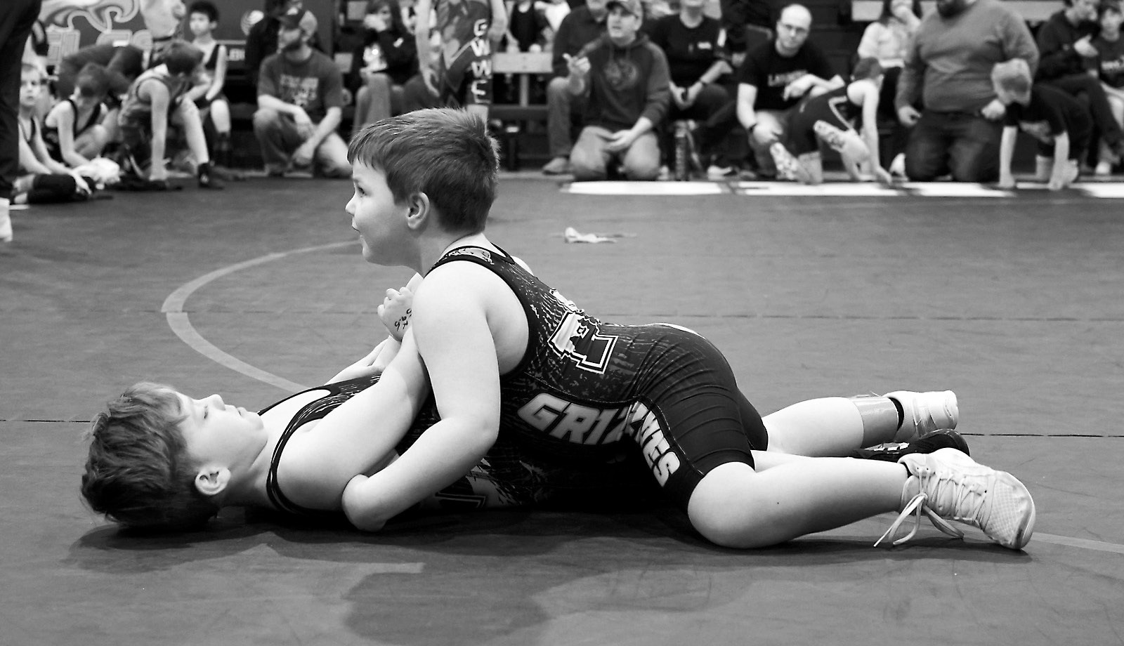 Malcolm Greenwood has his good friend, Ryder Henke, on his back to go for a pin. Photo by Larry Stokke.