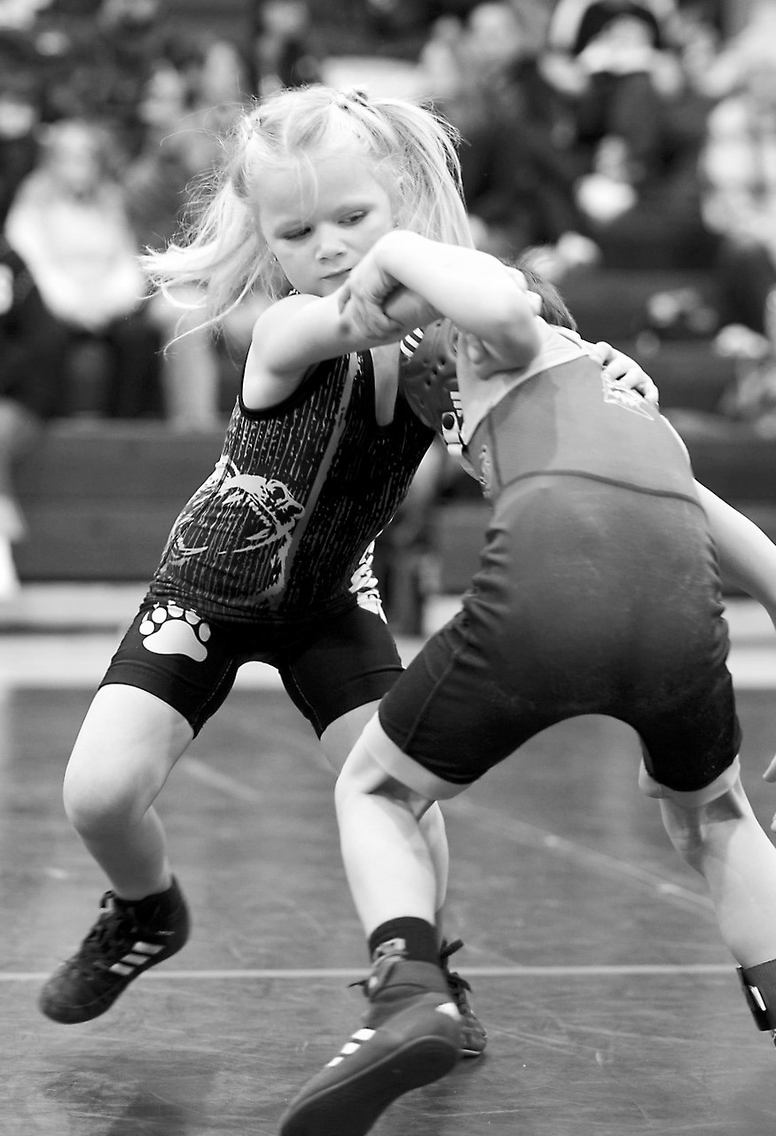 Cora Ford ties up her opponent and wrestles him to the mat. Photo by Larry Stokke.