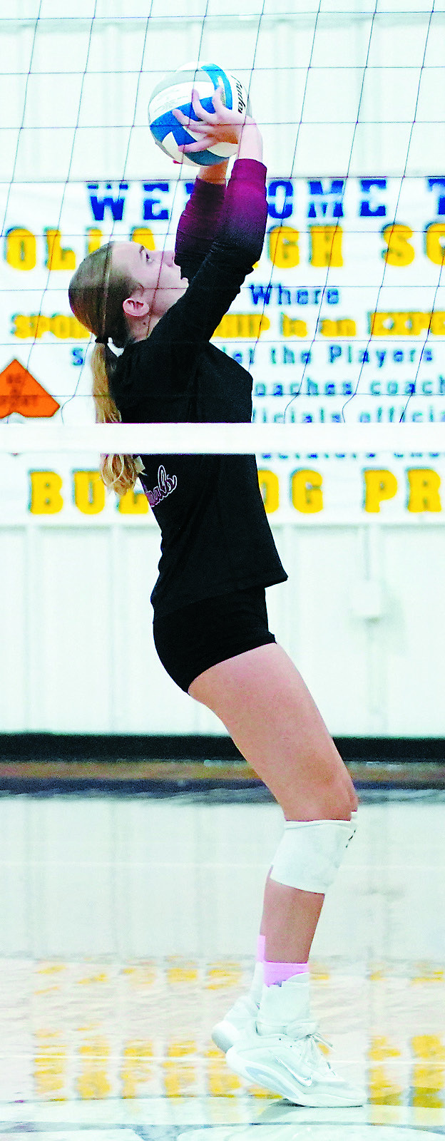 Kemi Morstad sets the ball to a teammate in the Cardinals' win over the Cougars. Photo by Larry Stokke.