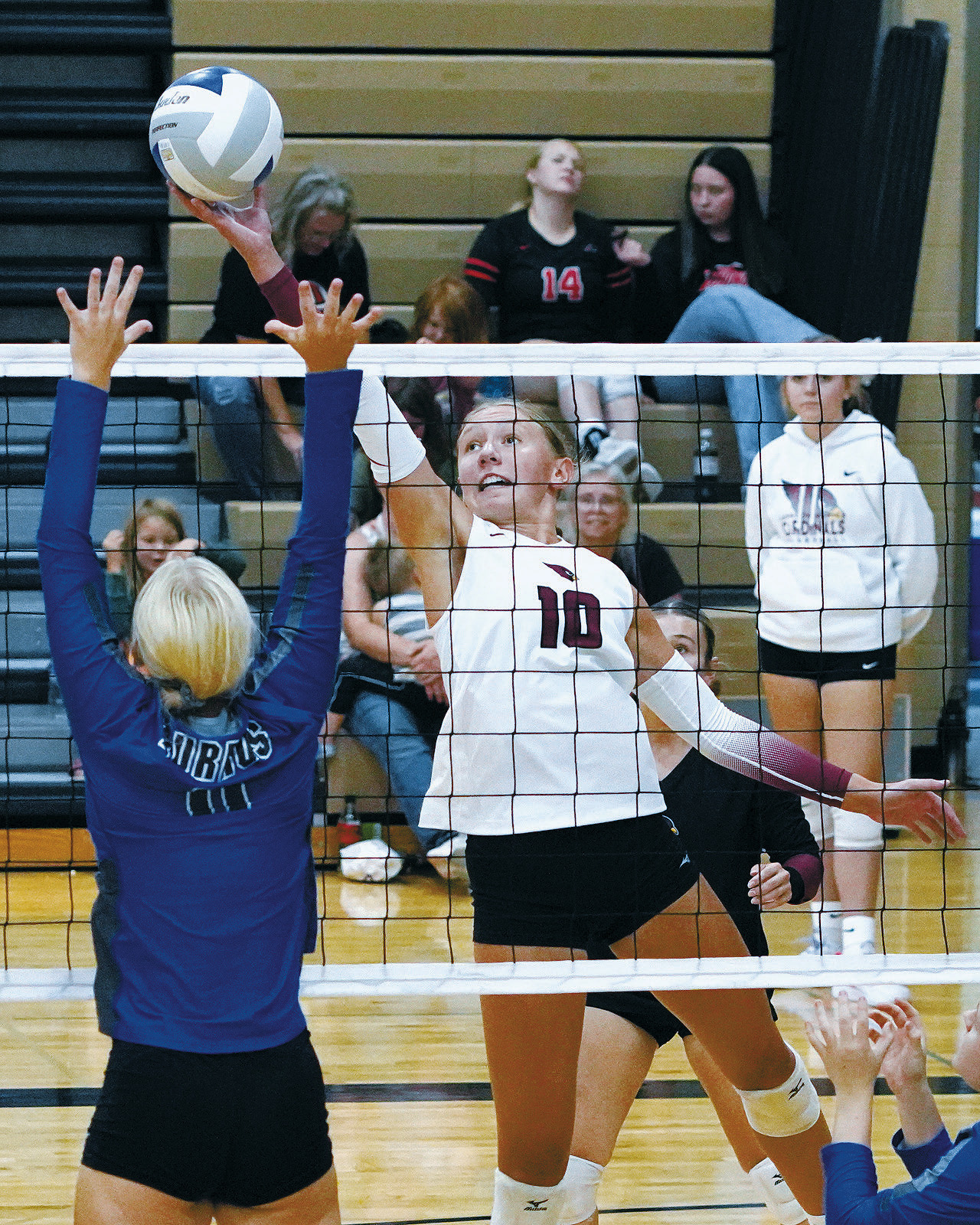Aubrey Badding sends the ball over a Burros player. Photo by Larry Stokke.