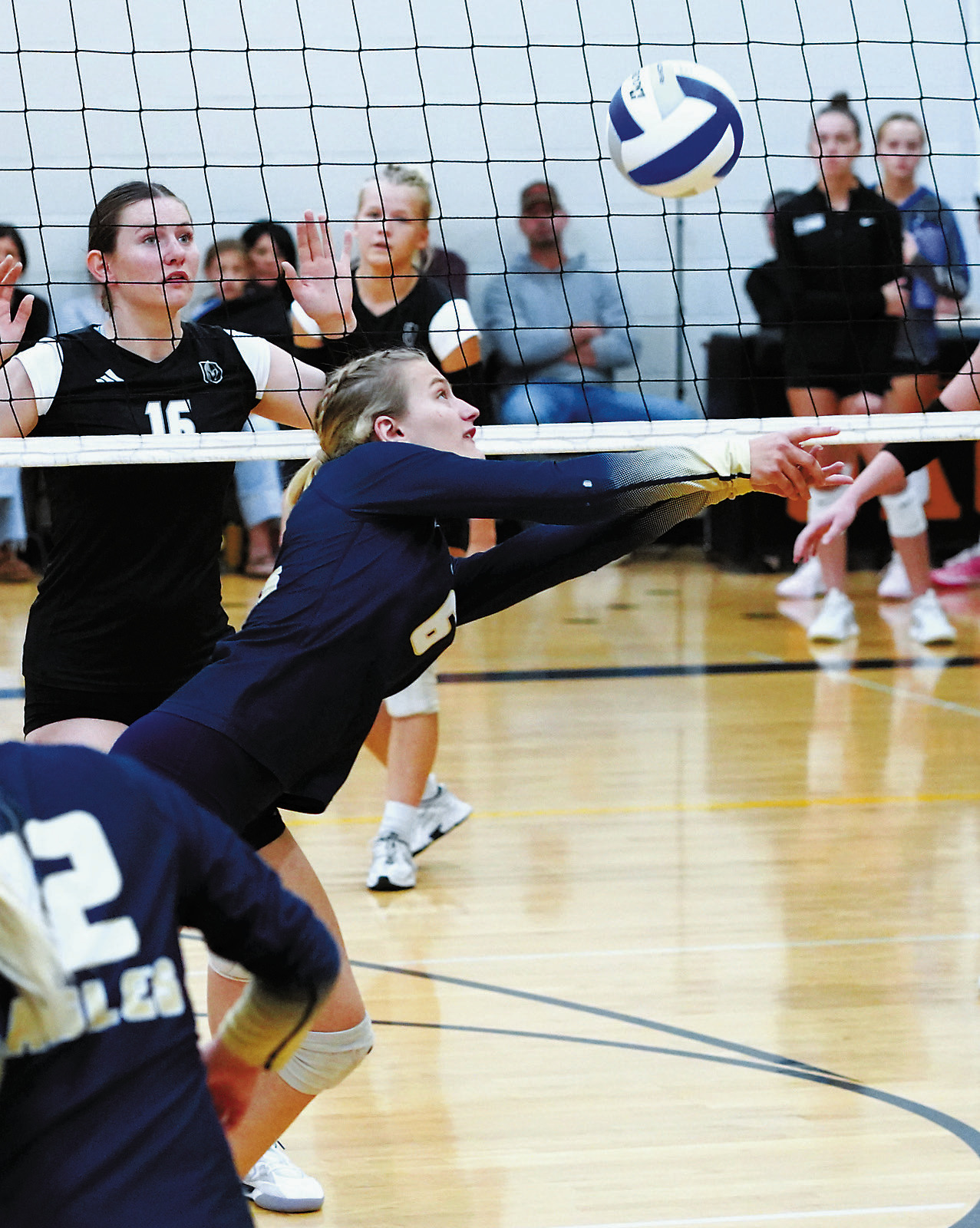 Dannika Bennett dives and sends the volleyball over the net in the game against the Titans at the Northern Cass Invitational. Photo by Larry Stokke.
