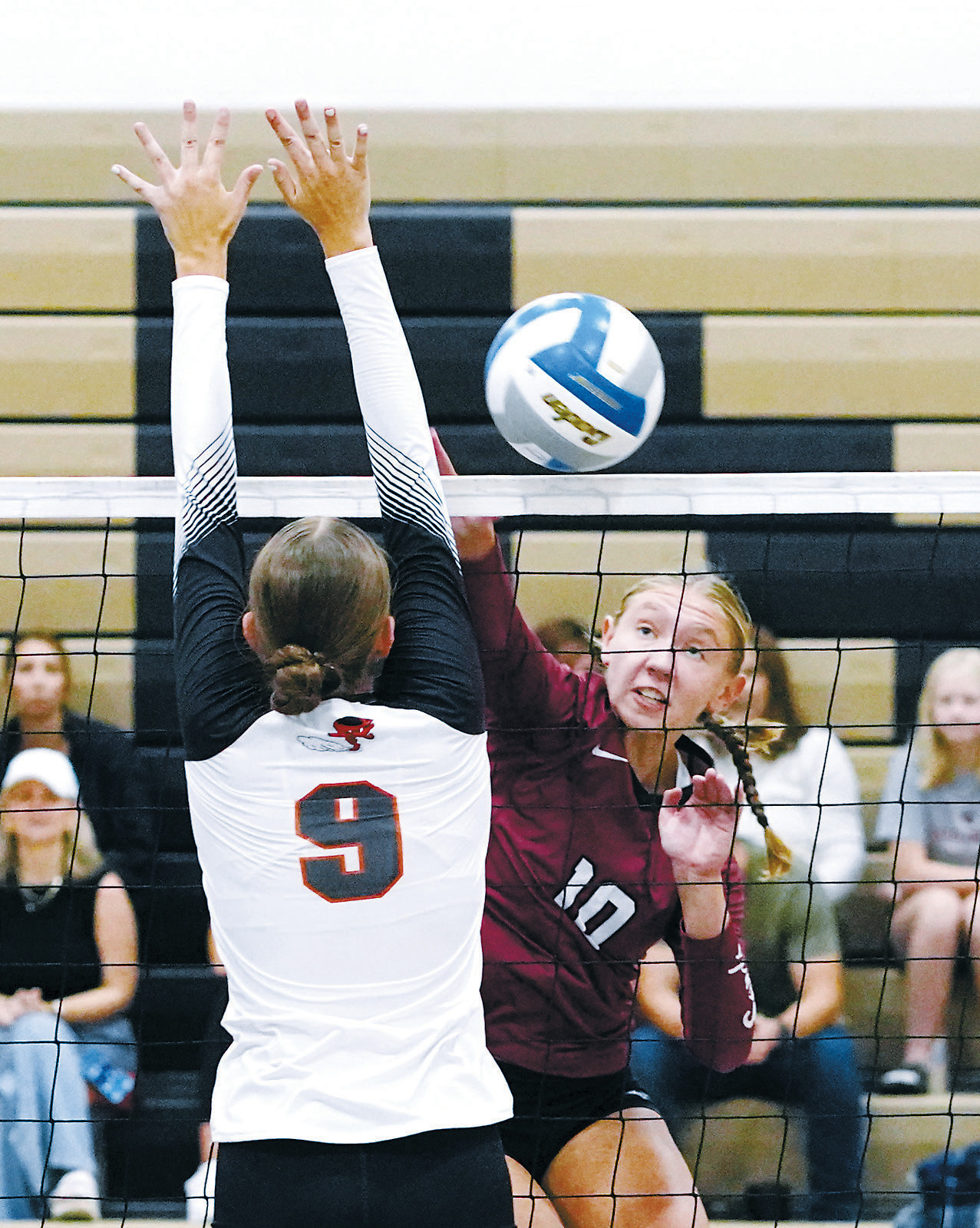 Aubrey Badding spikes the ball past a Tornado defender in the Northern Cass Invitational on Aug. 30. Photo by Larry Stokke.