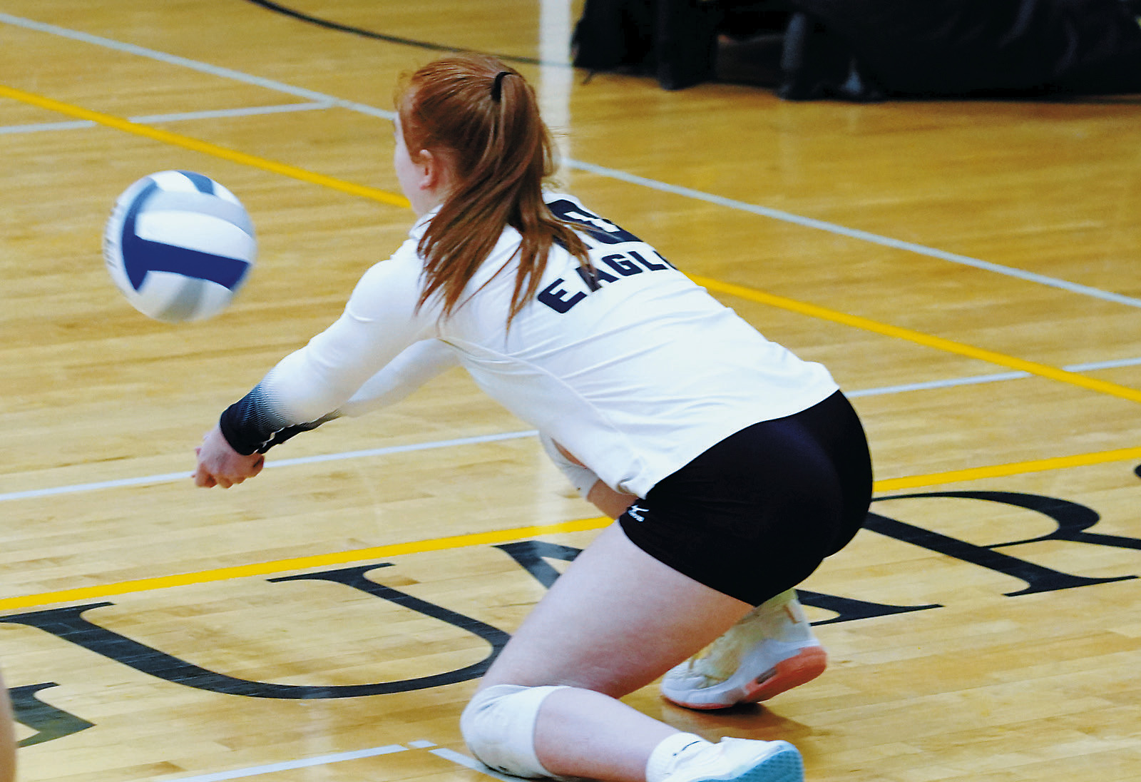 Marlie Stremick gets low and digs the ball to send it to a teammate. Photo by Larry Stokke.