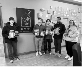 Pembina Honor Society students volunteered with Ronald McDonald House Charities, helping prepare meals and delivering donations collected by Pembina School students, including nearly 20 pounds of pop tabs and more than 100 donated items. Submitted photo