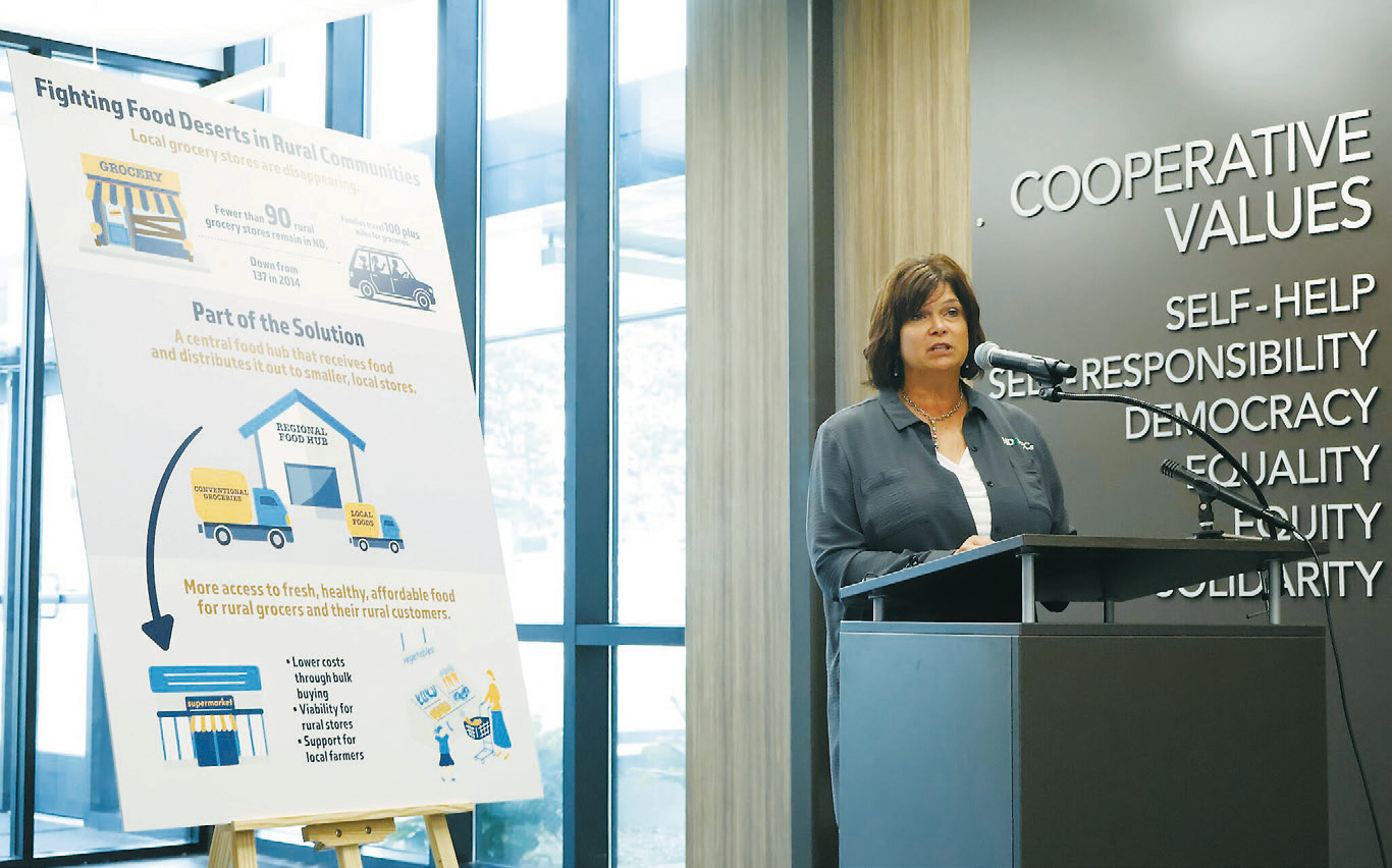 Ellen Huber, rural development director for the North Dakota Association of Rural Electric Cooperatives, speaks during a grant announcement on Aug. 4, 2025, in Mandan. The association is working to help sustain rural grocery stores. (Michael Achterling/North Dakota Monitor)