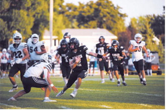North Border’s Kaden Moore, No. 2, carries the ball against the North Prairie Cougars on Friday, Aug. 21, in Pembina. Photo by Ashley Schafer