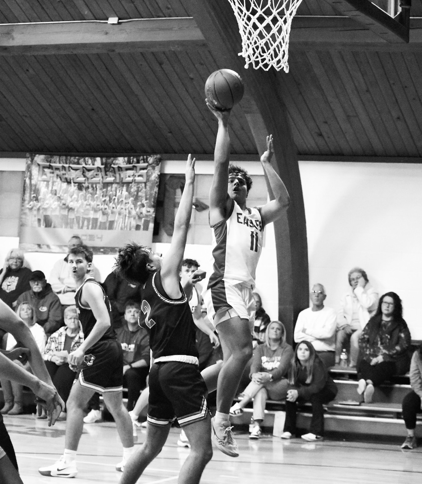 Grant Cosley goes up for a two pointer. Photo by Ashley Schafer.