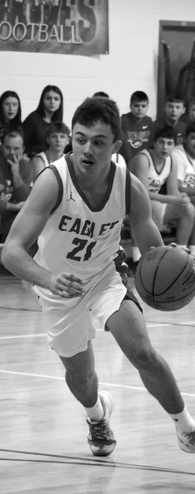 Brody Berg dribbles the ball around his opponents. Photo by Ashley Schafer.