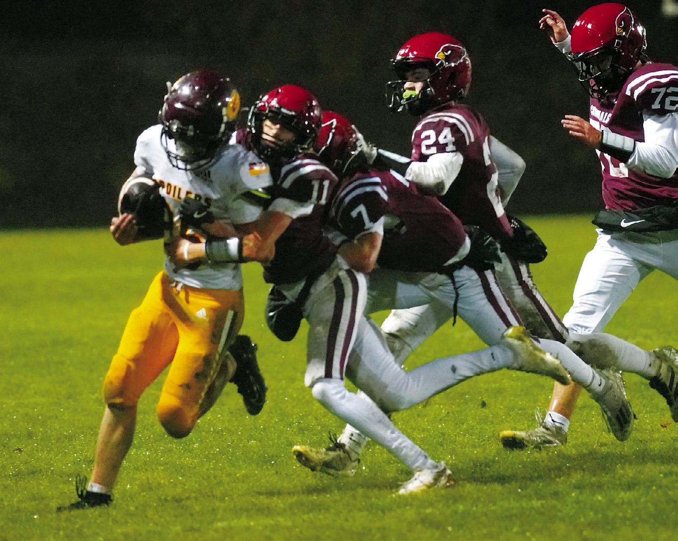 Karson Hanson with help from Connor Mitchell stops a Grafton Spoiler for a turnover in downs. Photo by Larry Stokke.
