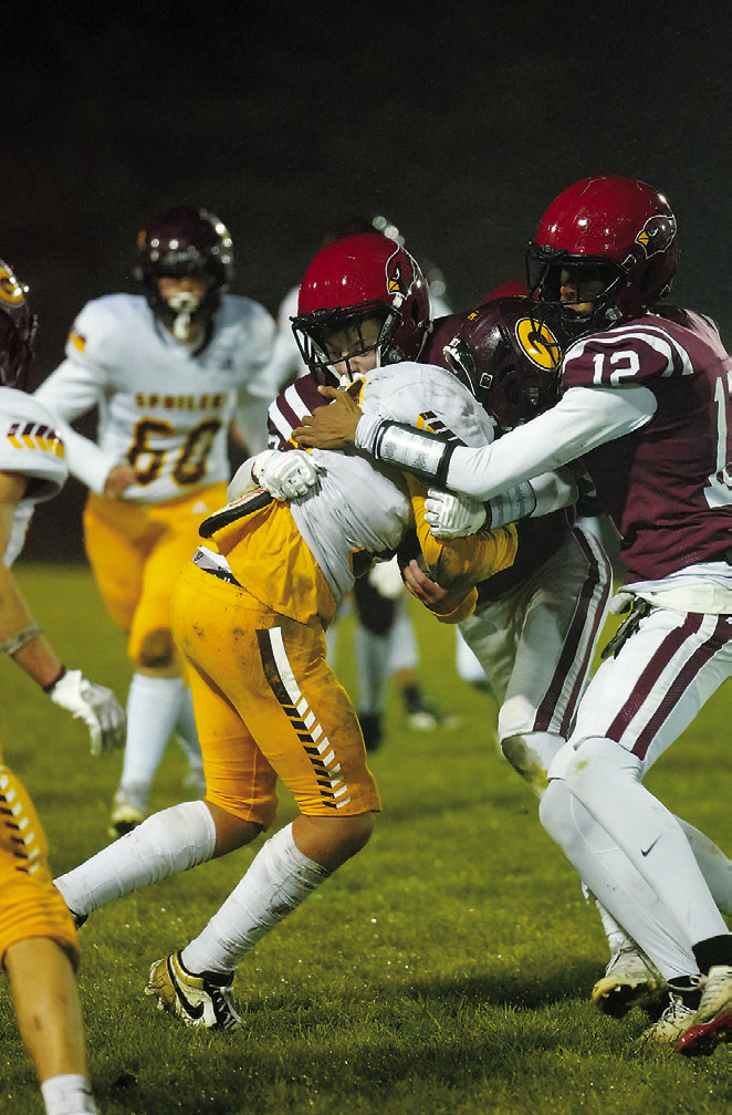 Austin Wenzel and FraShaun Kelso tie up the Spoiler ball carrier and are soon joined by a flock of Cardinals to stop any forward yardage gain. Photo by Larry Stokke.