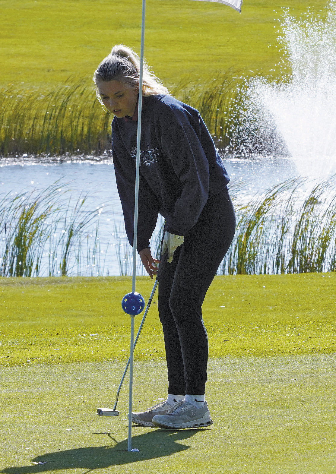 Rylee Medbery drops the ball in the cup at the Lakota Meet. Photo by Larry Stokke.